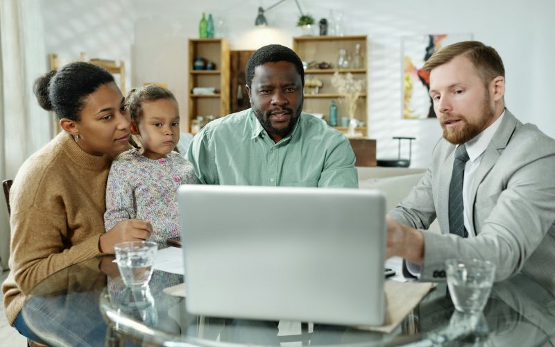 Consultant showing presentation to ethnic family